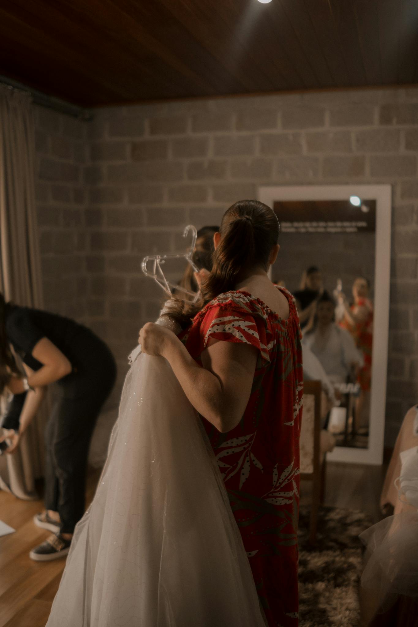 A behind-the-scenes view of bridal preparation, capturing the warmth and excitement of the moment.