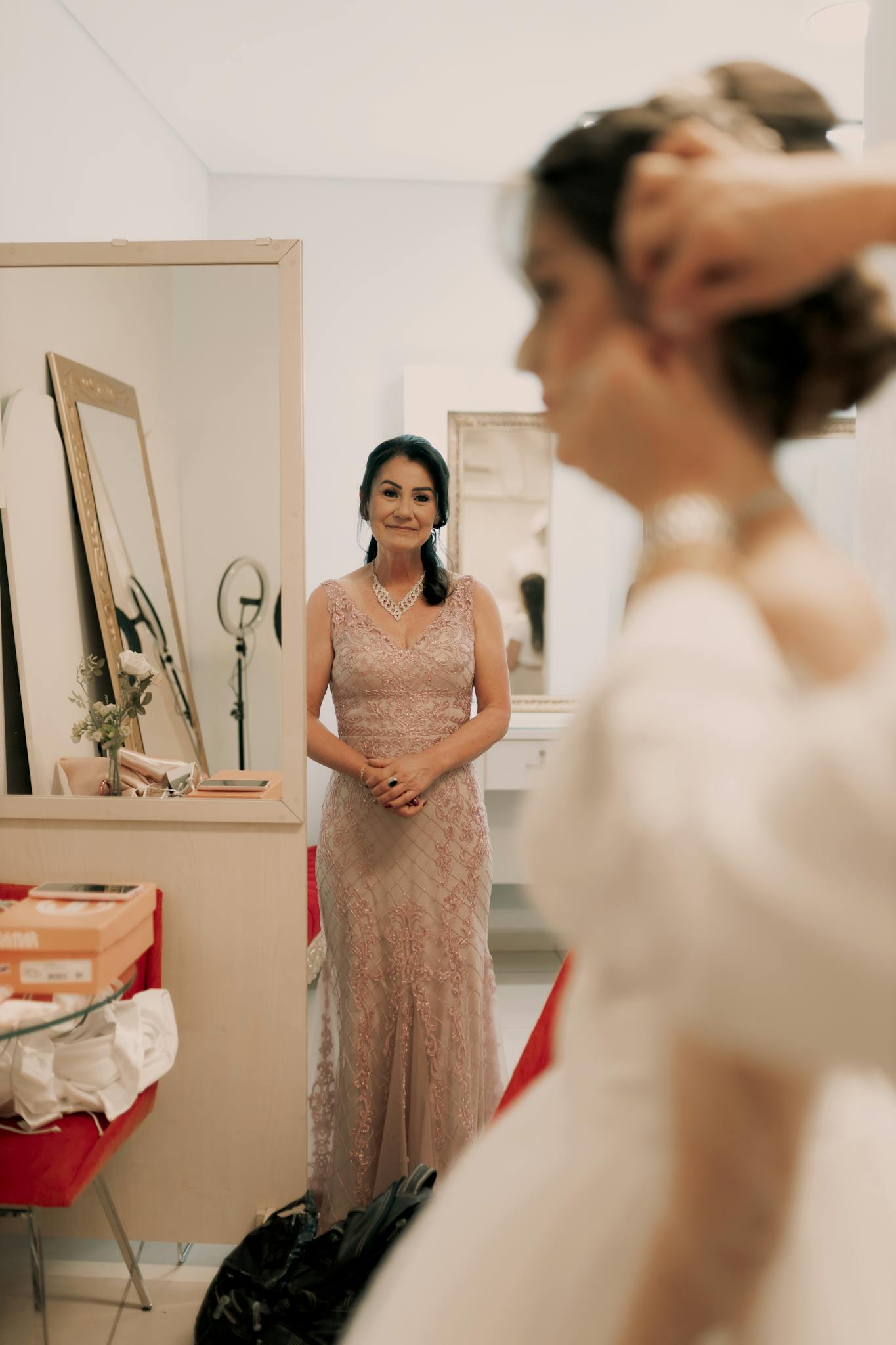 A bride and her mother in an intimate moment before the wedding ceremony.